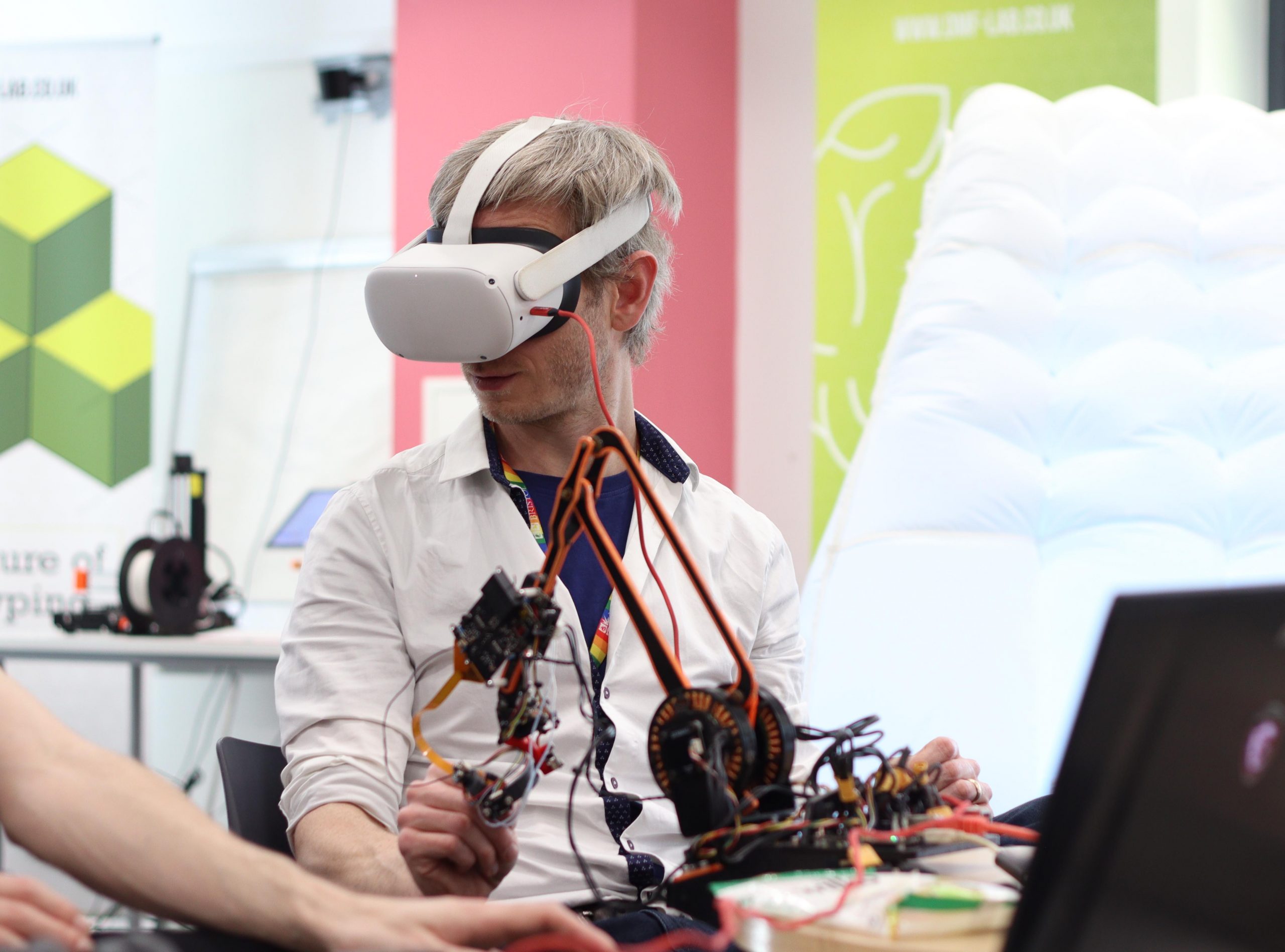 photo of someone demonstrating the use of a digital device while wearing a VR headset at the prosquared launch event