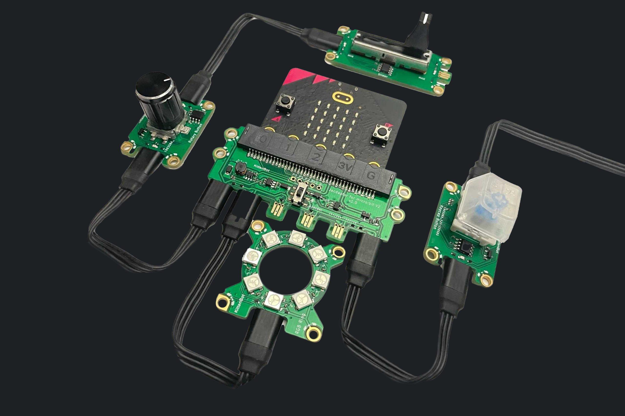 A photo of a micro:bit circuit board connected to a variety of Jacdac electronic components by black cables on a black background.