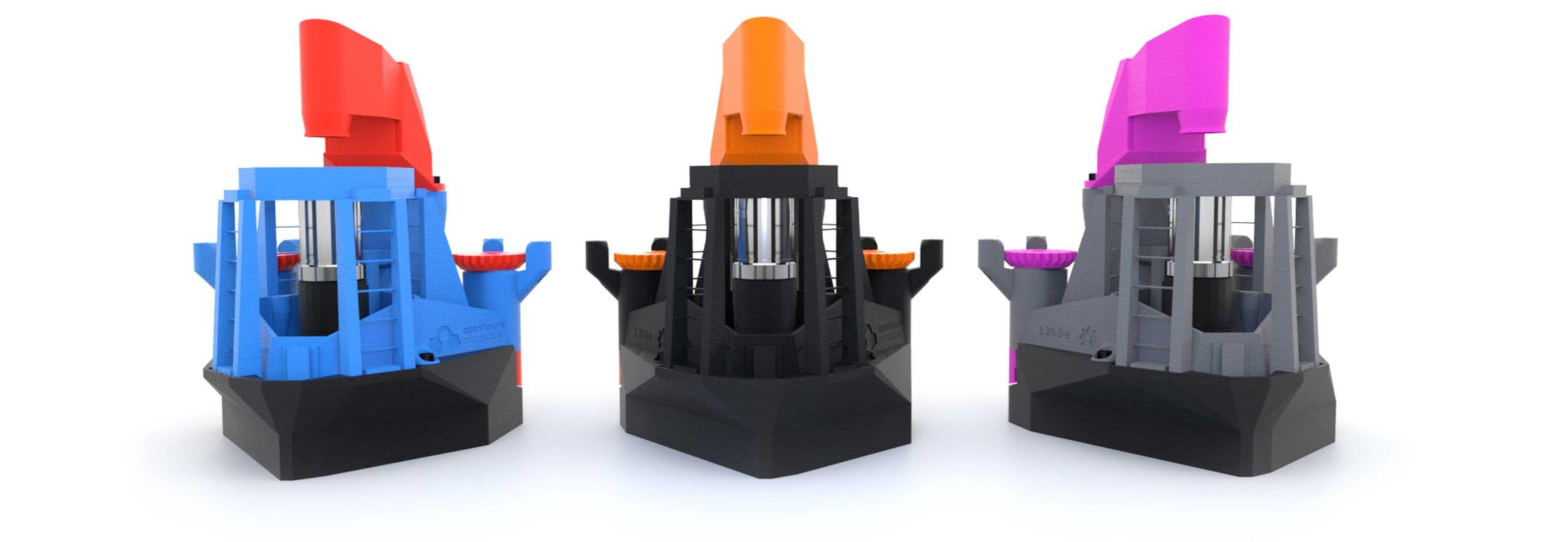 A photo of three OpenFlexure microscopes which have been 3D printed in bright colours against a white background.