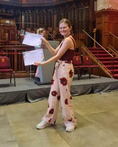 Eszter Vigh poses with two awards at the pre-CHI event.