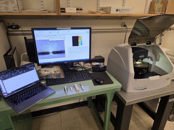 A photo of a workstation in a lab, with computers and other equipment on tables.